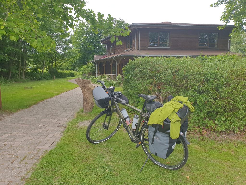 My touring bike in front of the beautiful wooden B&amp;B named Door's Logies